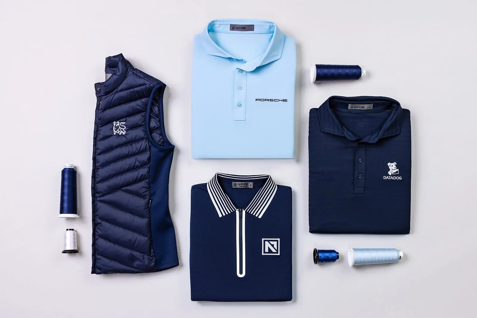 Custom embroidered polos, vests, and tees with company logos.