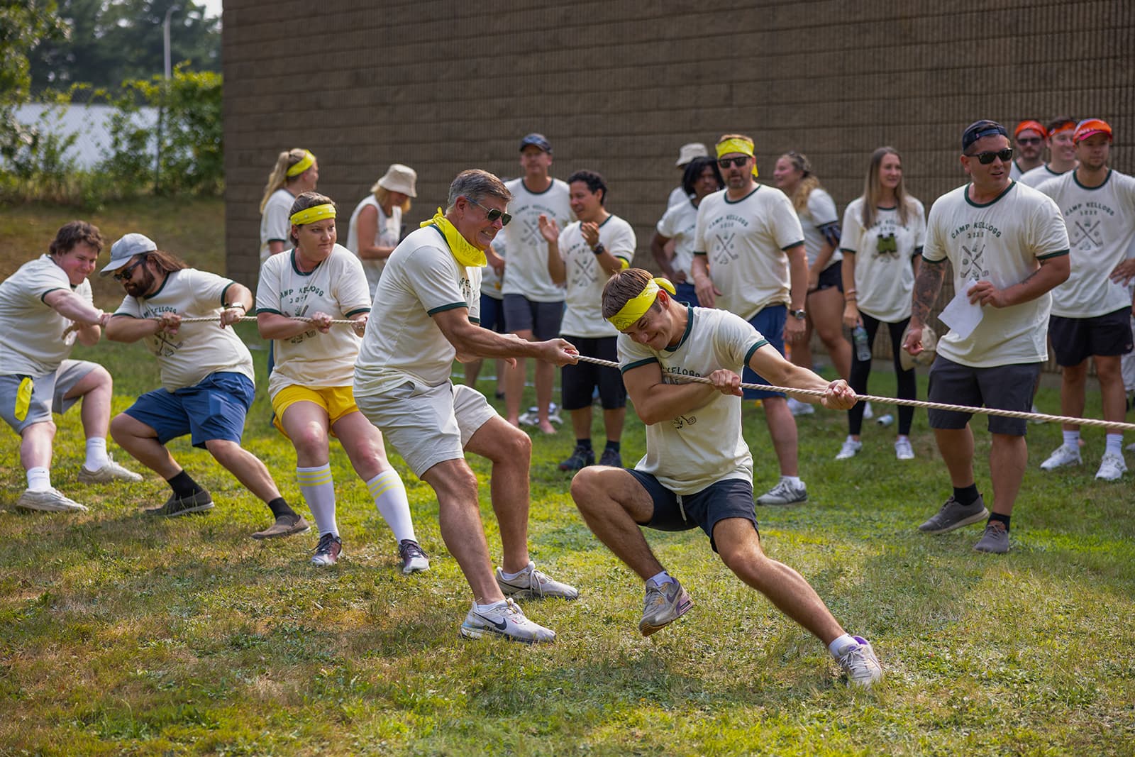 Team bonding at a ParsonsKellogg annual company picnic playing tug-of-war.